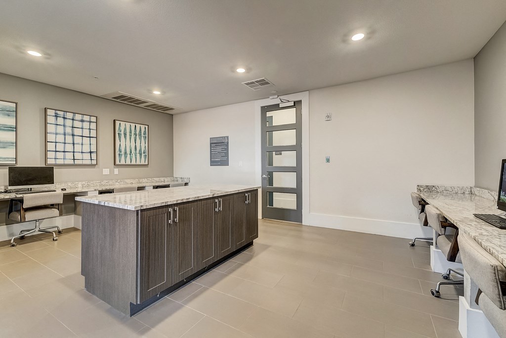 an office with a counter top and a desk with a computer