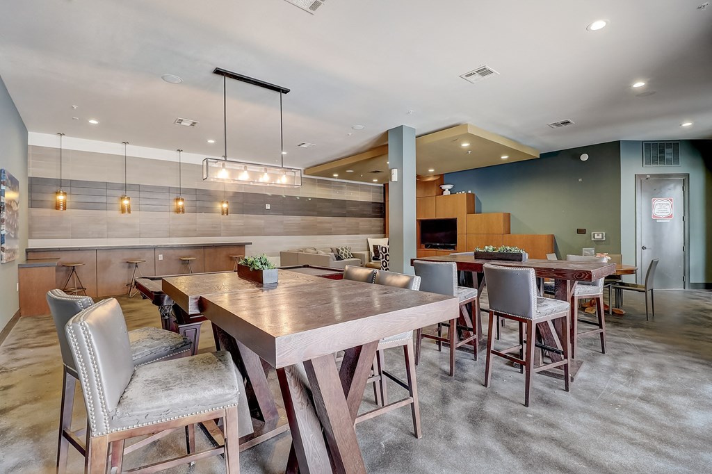 a large dining room with tables and chairs and a kitchen