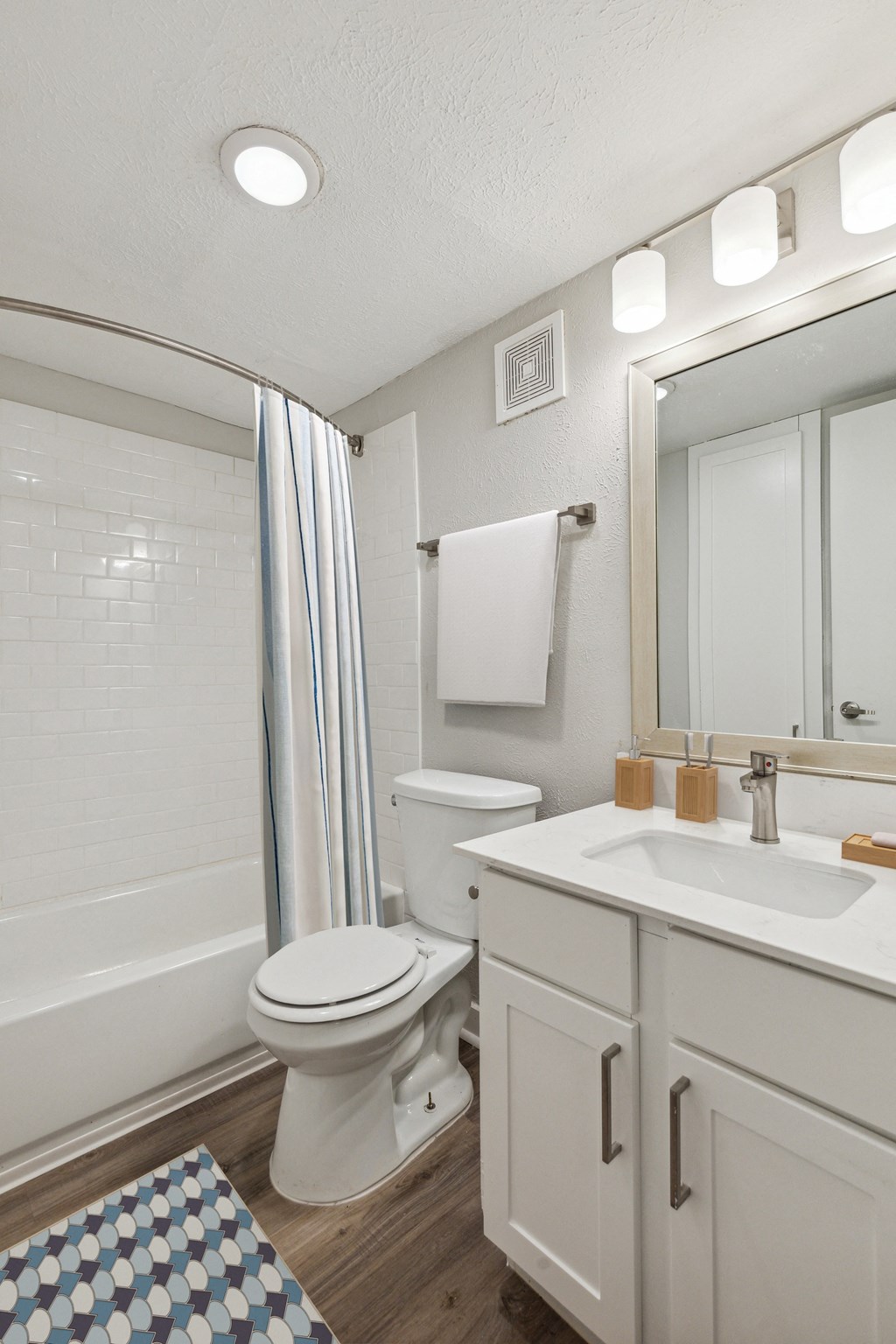 a bathroom with a white sink and toilet next to a bathtub with a shower curtain