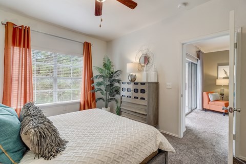 a bedroom with a large bed and a ceiling fan