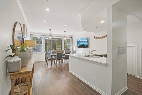 A kitchen with a dining table and chairs.