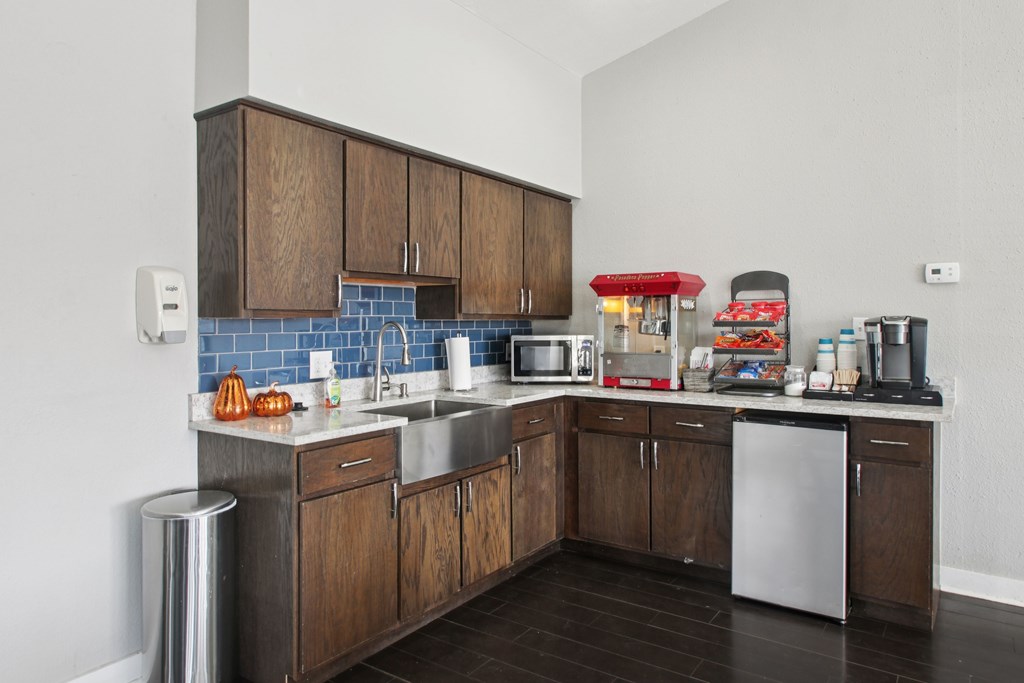 A kitchen with brown cabinets and a white dishwasher.