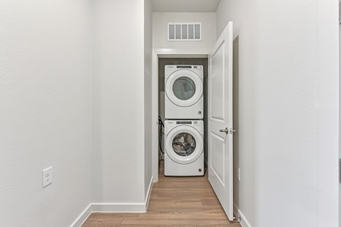 A white washer and dryer in a small laundry room.