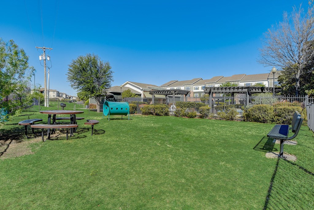 a backyard with a picnic table and a playground