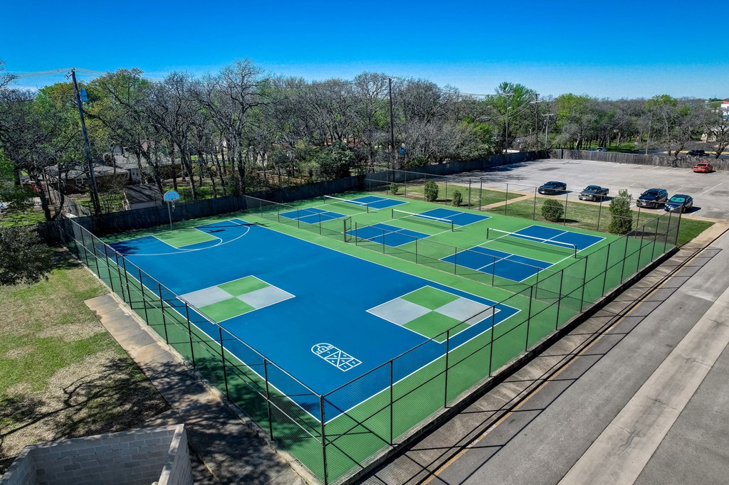 an aerial view of a tennis court on a city street