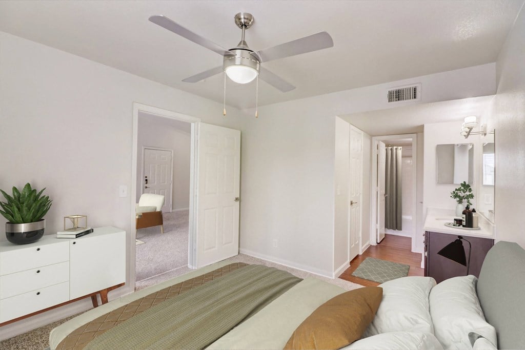 a bedroom with a large bed and a ceiling fan
