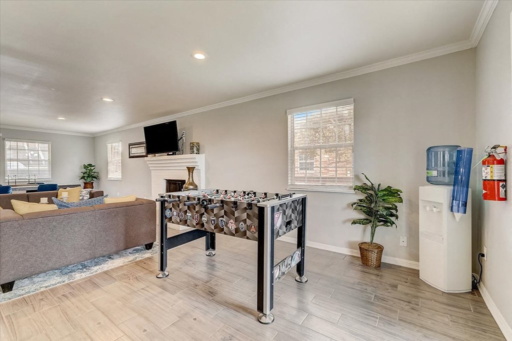 a game room with a foosball table and a couch