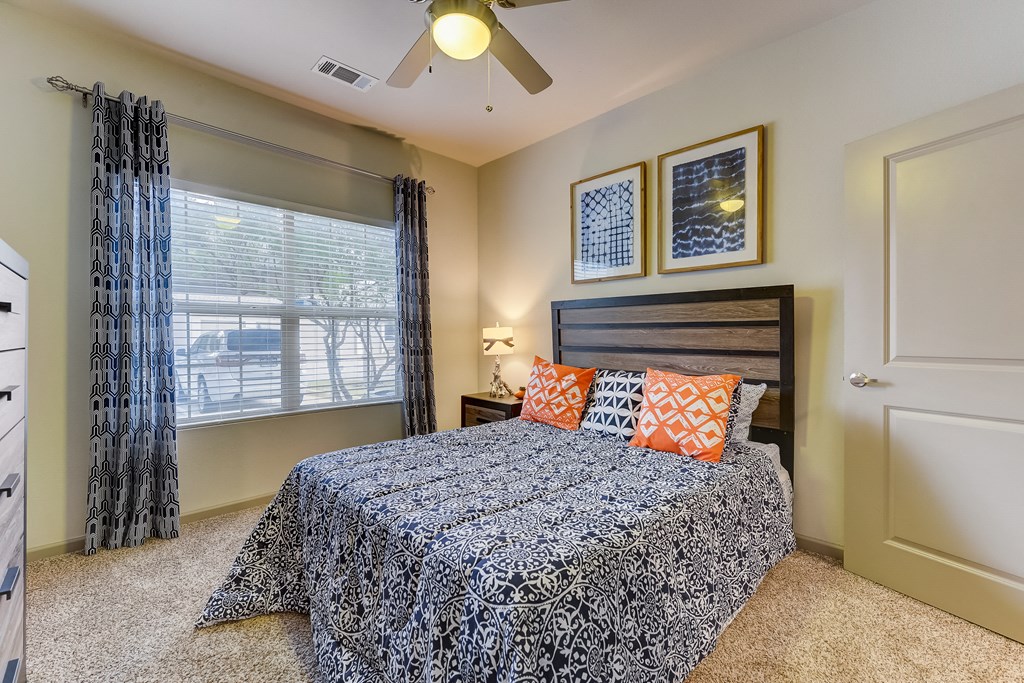 a bedroom with a bed and a ceiling fan