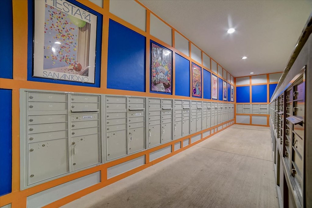 a locker room with many mailboxes and paintings on the wall