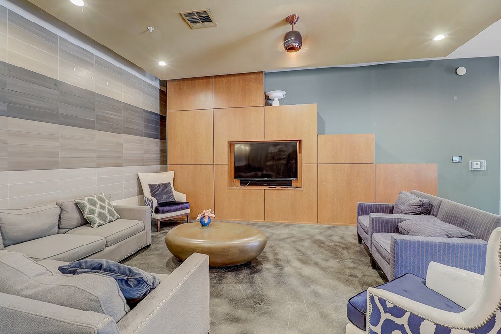 a living room with couches and chairs and a television