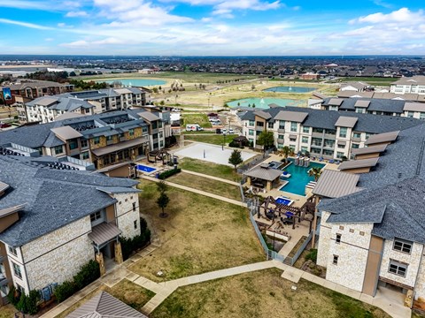 an aerial view of a community with houses and a pool