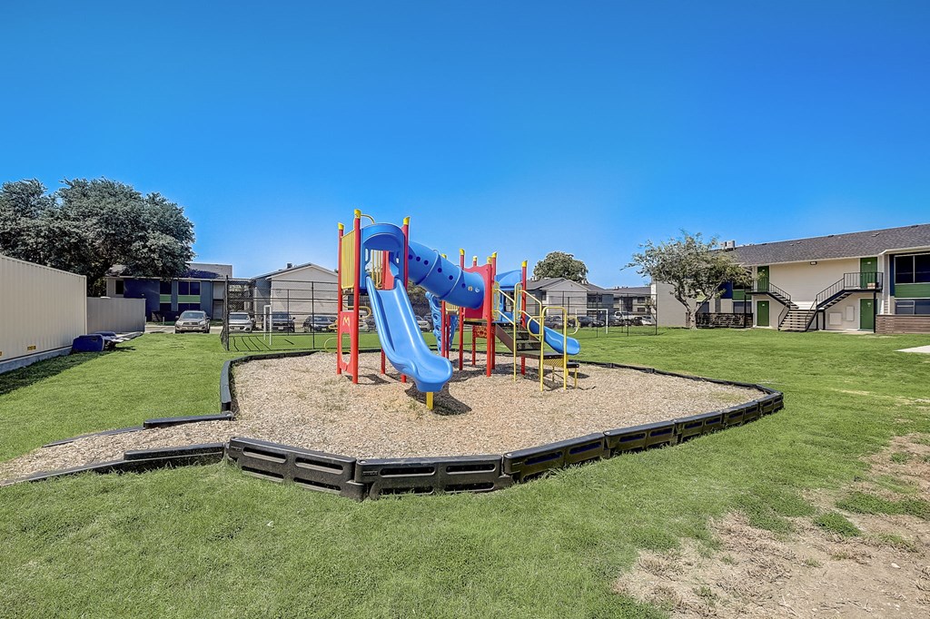 a playground at the enclave at woodbridge apartments in sugar land, tx