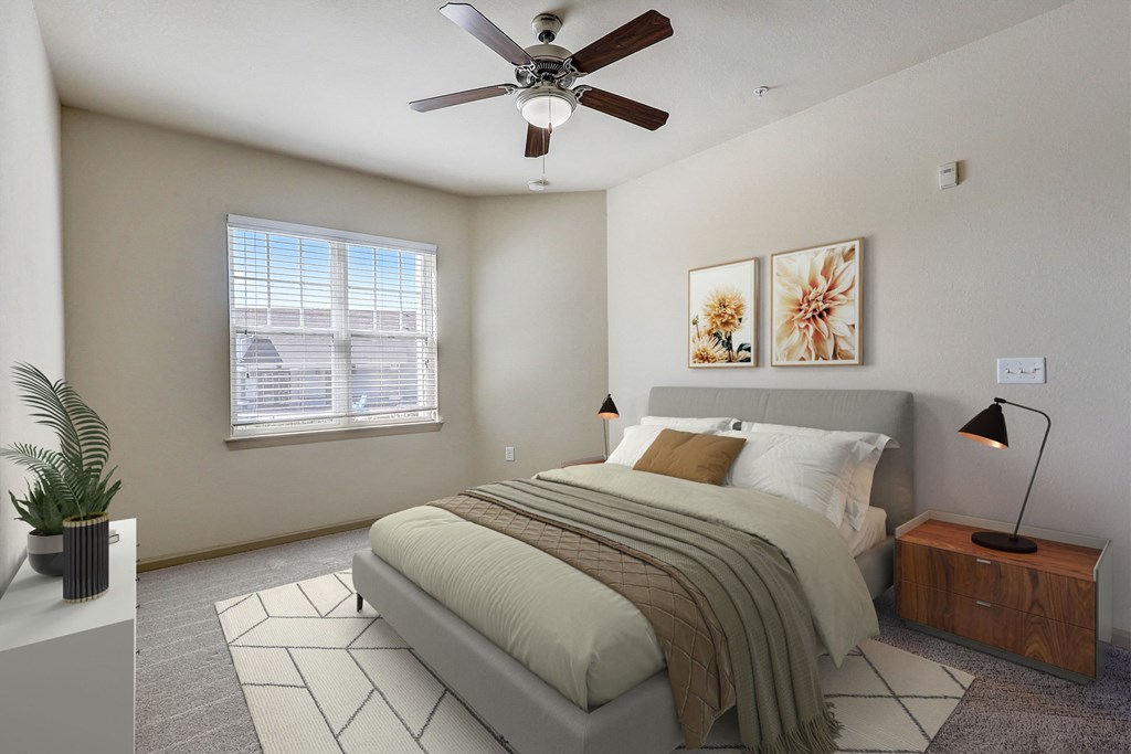 a bedroom with a bed and a ceiling fan