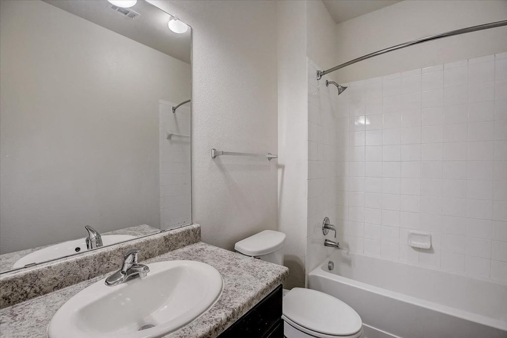 a bathroom with a sink toilet and a tub