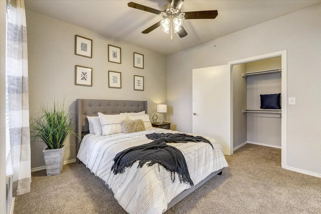 a bedroom with a bed and a ceiling fan