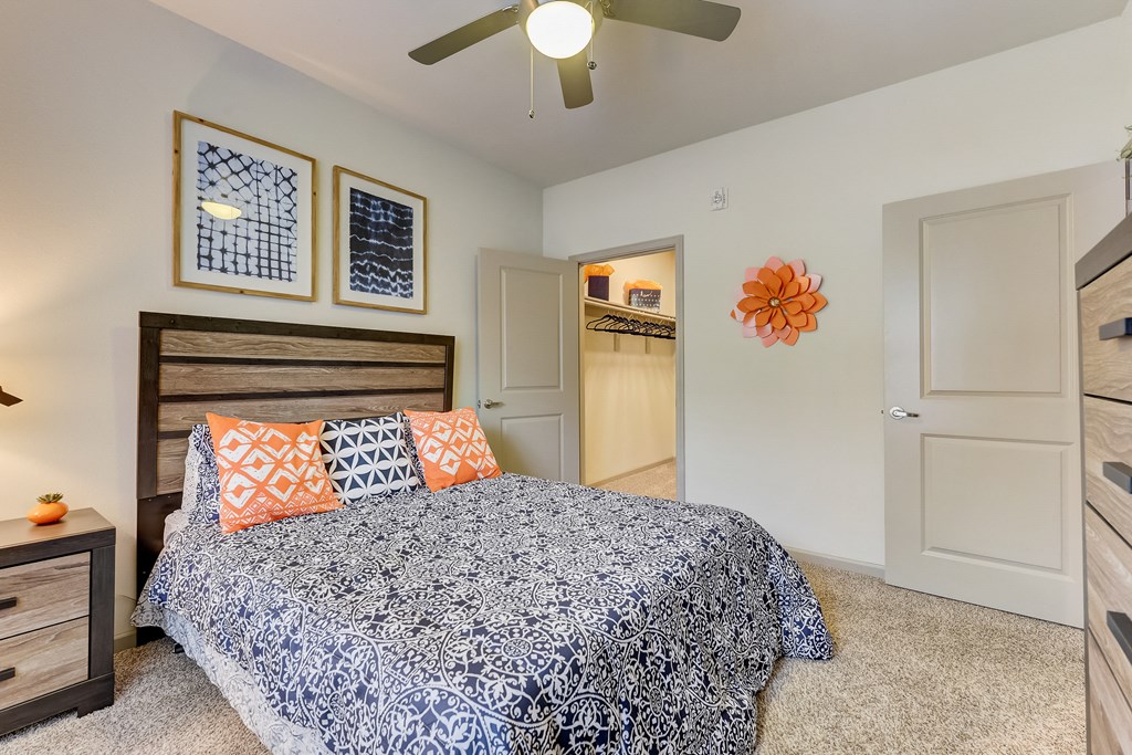 a bedroom with a bed and a ceiling fan