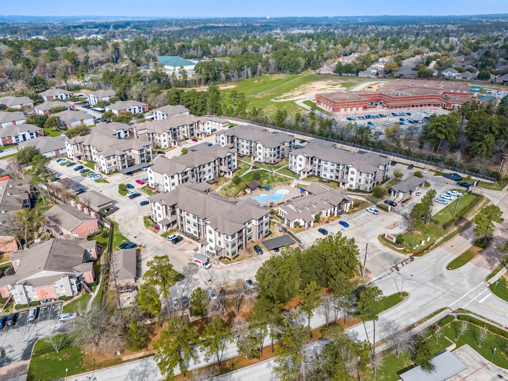 an aerial view of a group of apartment buildings and a parking lot