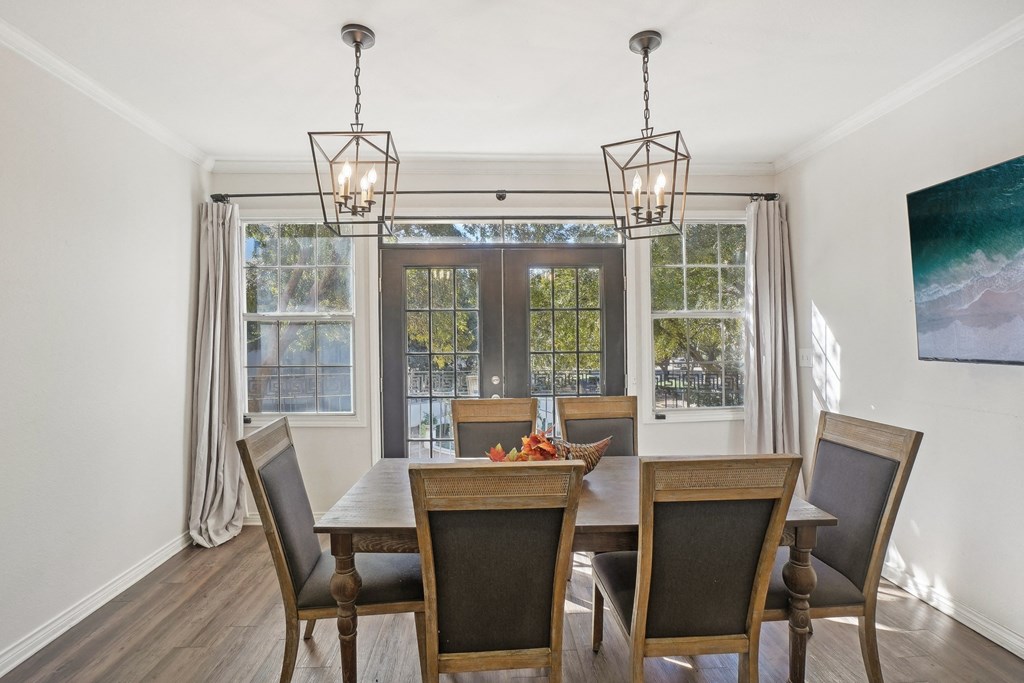 A dining room with a table set for four.