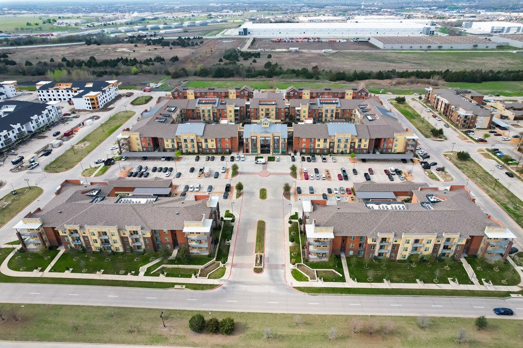 an aerial view of an apartment complex in a parking lot