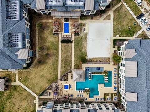 arial view of a house with a pool and a yard