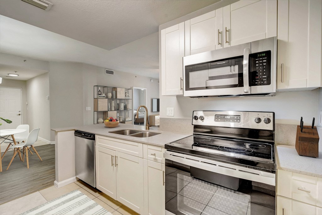 a kitchen with stainless steel appliances and white cabinets