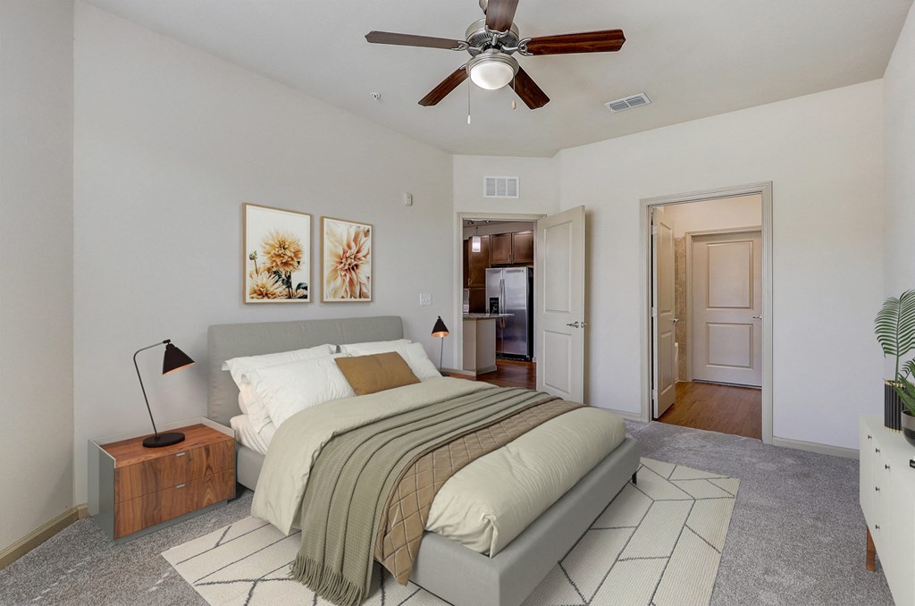 a bedroom with a bed and a ceiling fan