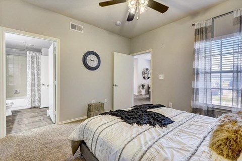 a bedroom with a bed and a ceiling fan