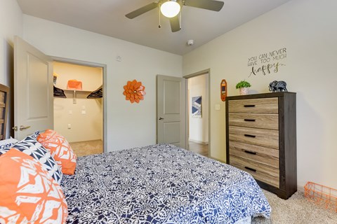 a bedroom with a bed and a ceiling fan