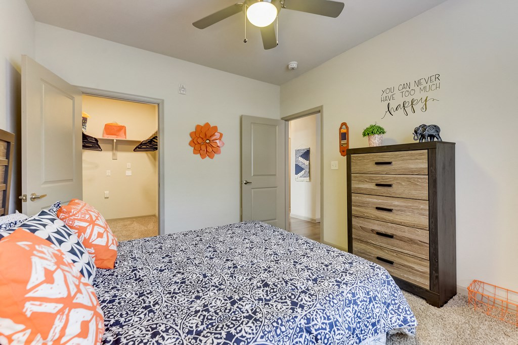 a bedroom with a bed and a ceiling fan