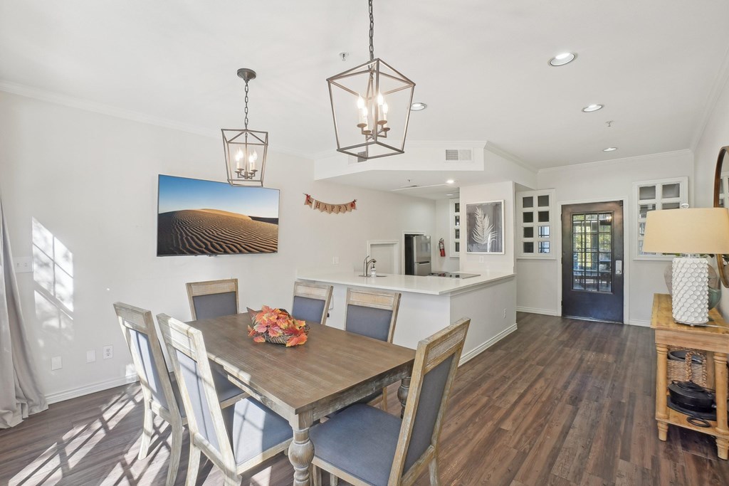 A dining room with a wooden table and chairs.