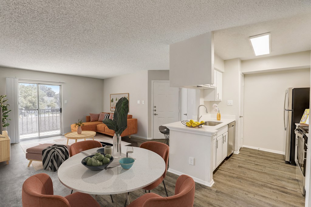 an open kitchen living room and dining room with a table and chairs