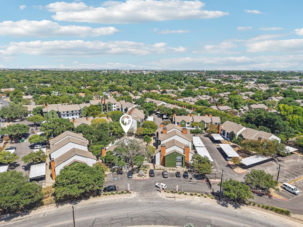 A bird's eye view of a residential area with a church in the center.