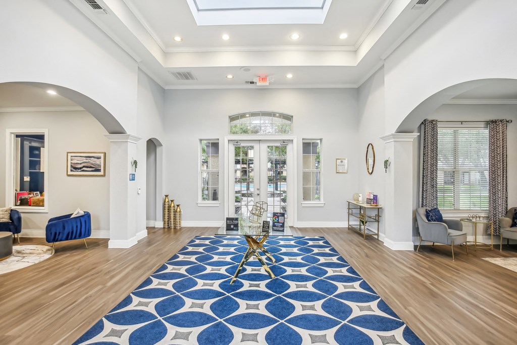 A large blue and white rug is on the floor of a spacious room.