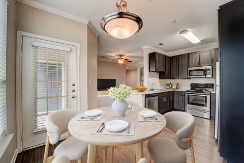 a kitchen and dining room with a table and chairs