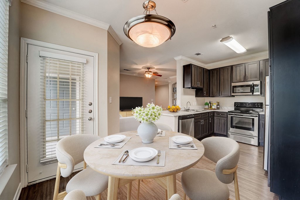 a kitchen and dining room with a table and chairs