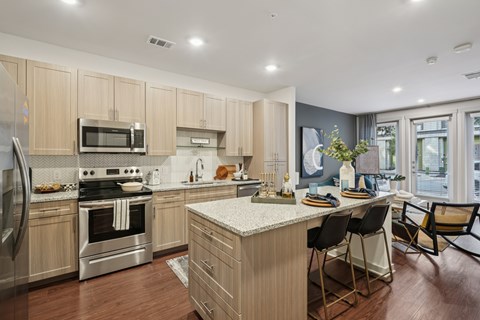 A modern kitchen with wooden cabinets and stainless steel appliances.