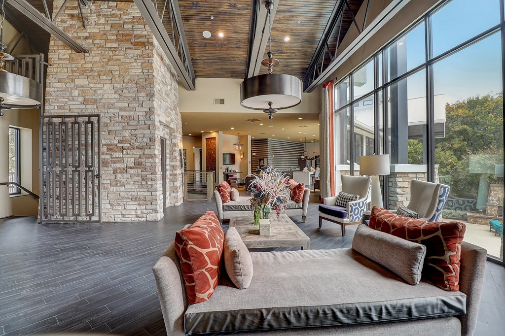 a living room with furniture and large windows