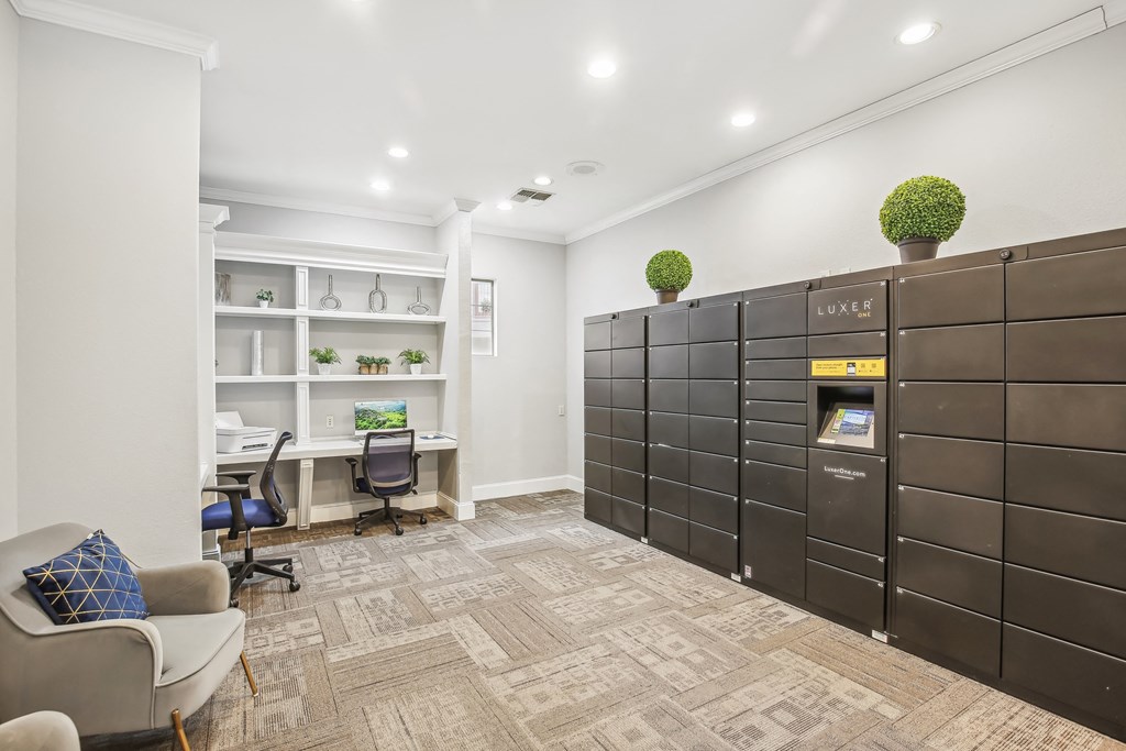 A room with a couch, chairs, and a desk with a computer on it.