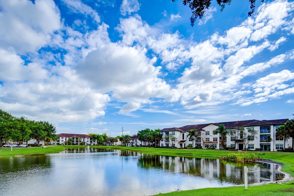 a body of water with apartment buildings on the other side of it