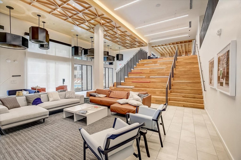 a lobby with couches and chairs and a staircase