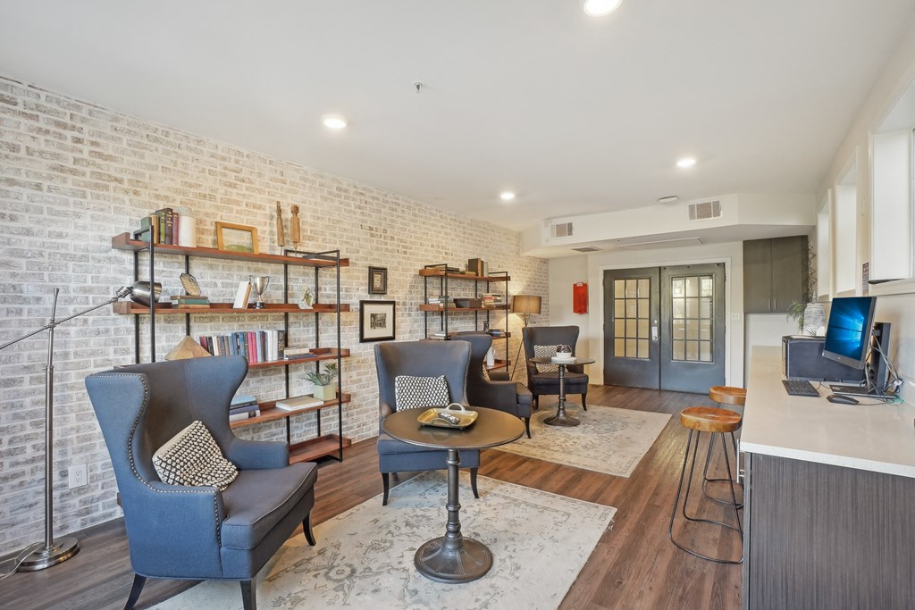A living room with a brick wall and a television.
