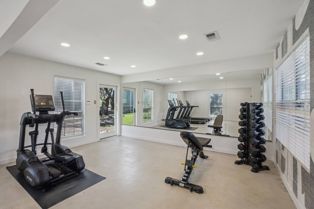 A spacious home gym with a variety of exercise equipment.