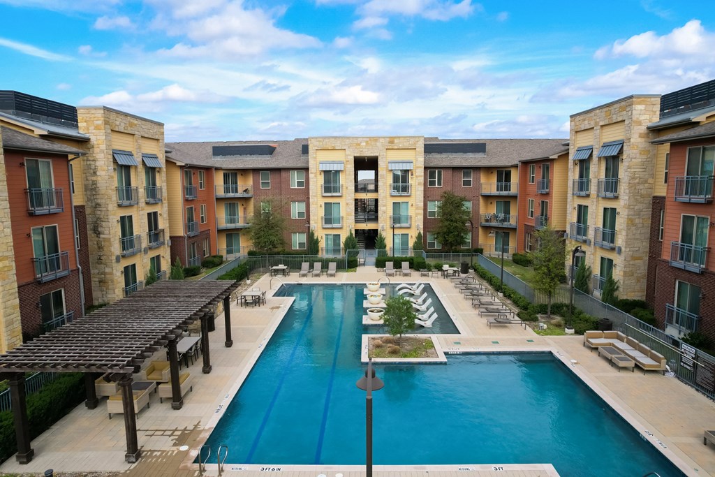 an aerial view of an apartment complex with a large pool