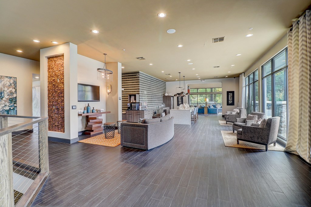 a large lobby with couches and chairs and a television