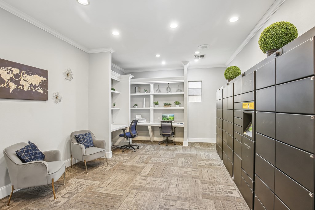 A room with a carpeted floor, a desk with a chair, and a bookshelf.