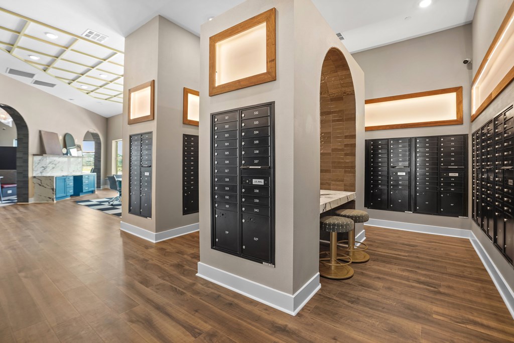 A room with wooden floors and black cabinets with light brown trim.