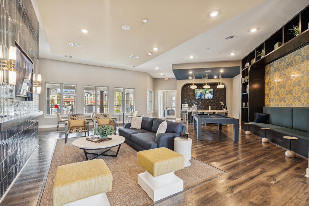 A modern living room with a black couch and a coffee table.