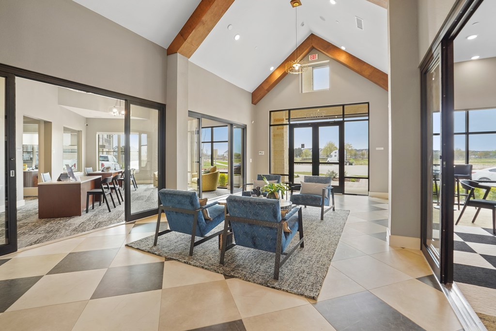 A spacious living room with a checkered floor and a large window.