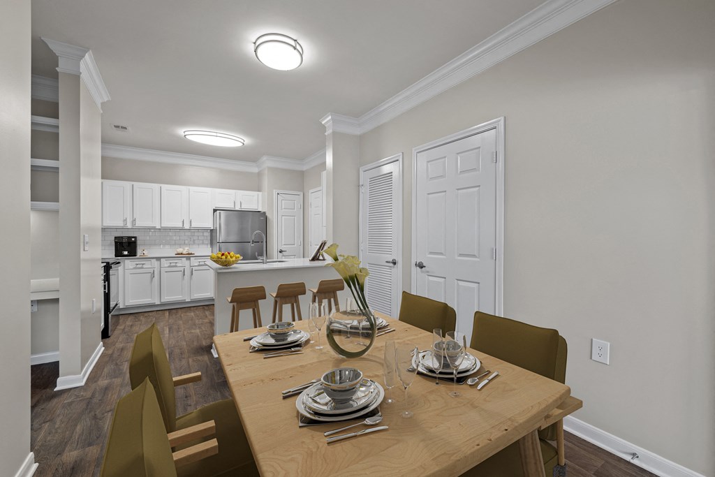 a dining room and kitchen with a wooden table and chairs