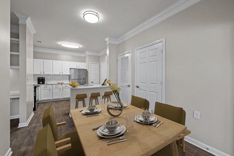 a dining room and kitchen with a wooden table and chairs